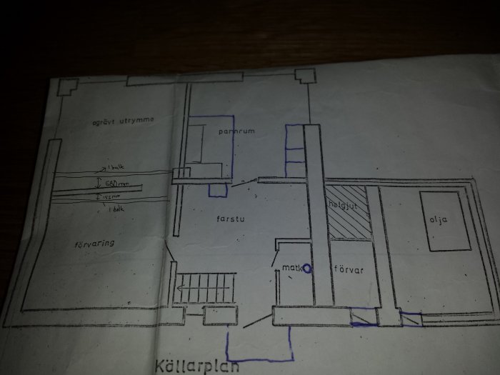 Floor plan sketch of a basement, showing labeled areas for storage, a boiler room, stairs, and oil storage. Includes measurements and beam placements.
