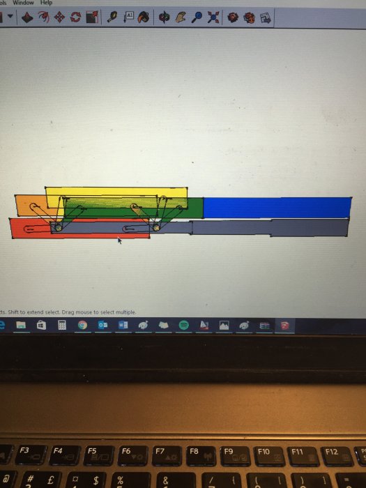 Skiss av en mekanisk konstruktion med fjäderbelastning på en datorskärm, ovanpå ett tangentbord.