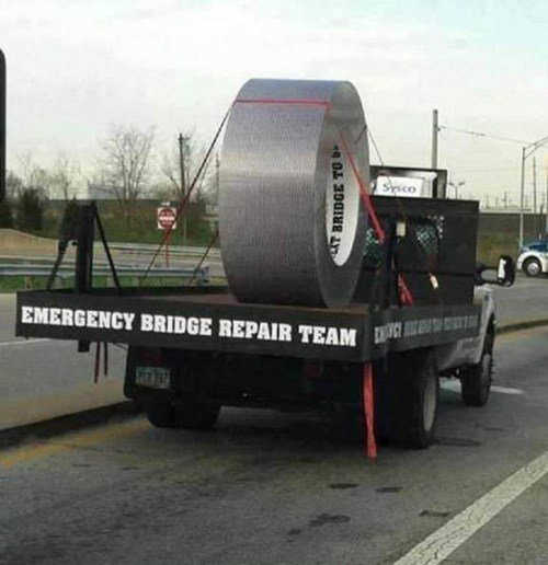 Lastbil med stor metallrulle och skylten "Emergency Bridge Repair Team" på sidan.