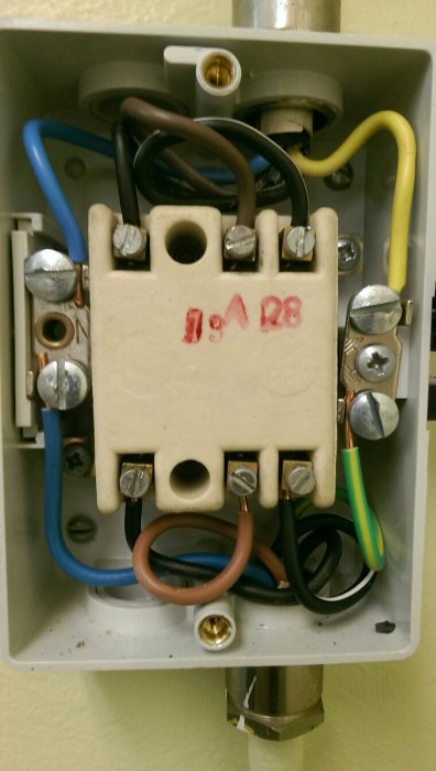 Eluttag med flera anslutna kablar och en markerad säkring på 16A i en överbelastad elinstallation.