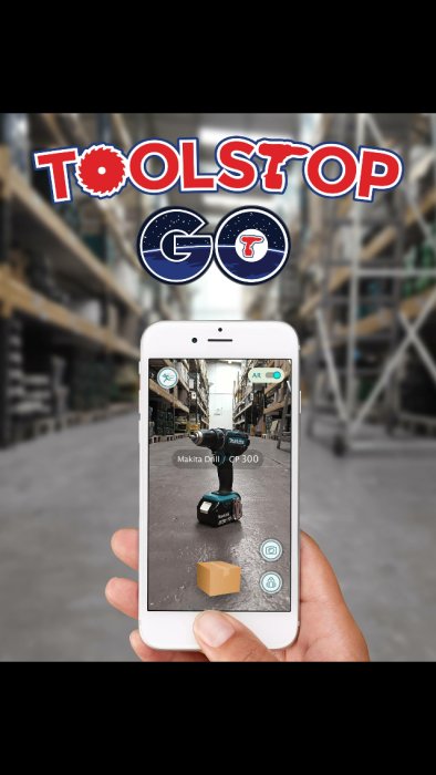 Smartphone som visar ett förstärkt verklighetsspel, 'Toolstop GO', med en virtuell Makita-borrmaskin i en verkstadsmiljö.