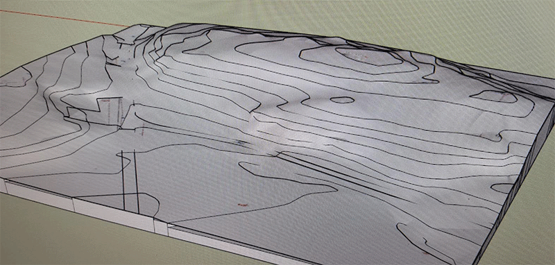 Skärmdump av 3D-karta i Sketchup med terränglinjer och en fotograferad skärm.