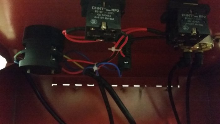Elektrisk installation med kontakter och färgglada kablar, möjligen för en saxlyft.