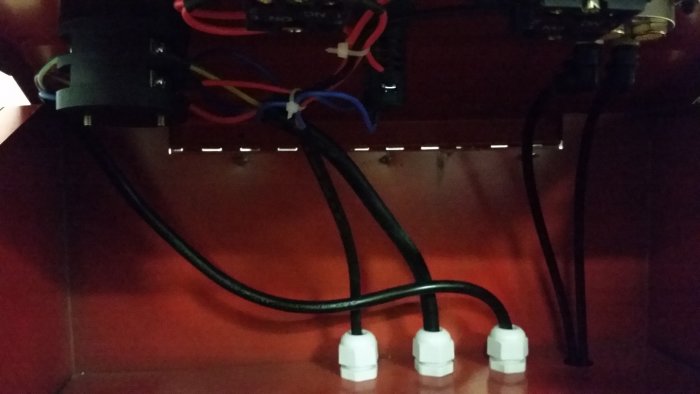 Interiör av en saxlyft med synliga elektriska komponenter och ledningsdragning.