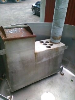 Hemmagjord badtunna gjord av rostfri mjölktank med aluminiumkamin och skorsten, före installation av trädetaljer.