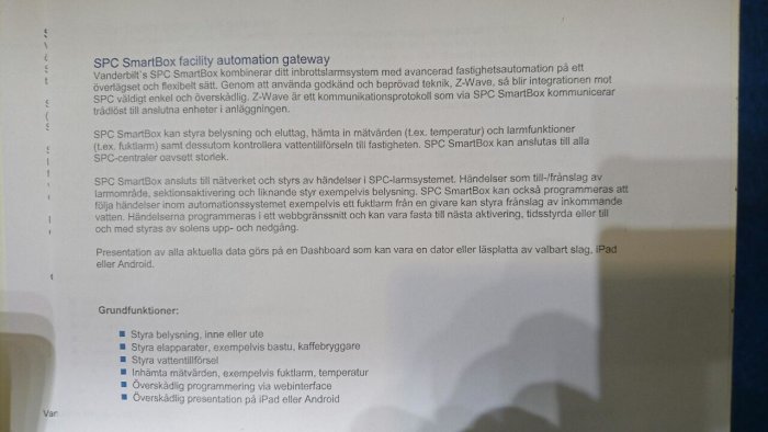 Beskrivande text om en SPC SmartBox för fastighetsautomation och dess funktioner, med suddig bakgrund.