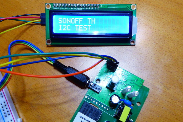 Elektronikkomponenter med texten SONOFF TH I2C TEST på en LCD-display ansluten med färgglada kablar.