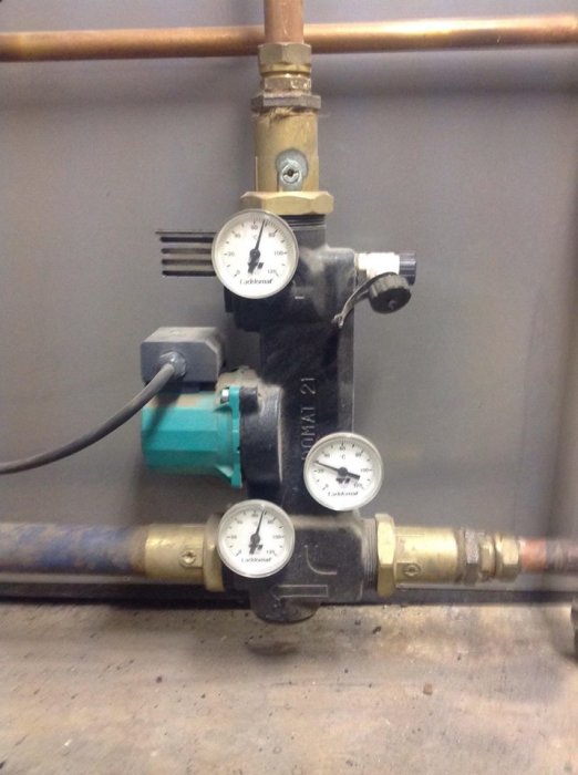 Laddomat med pump och tre mätare för temperatur i en värmepanna-installation.