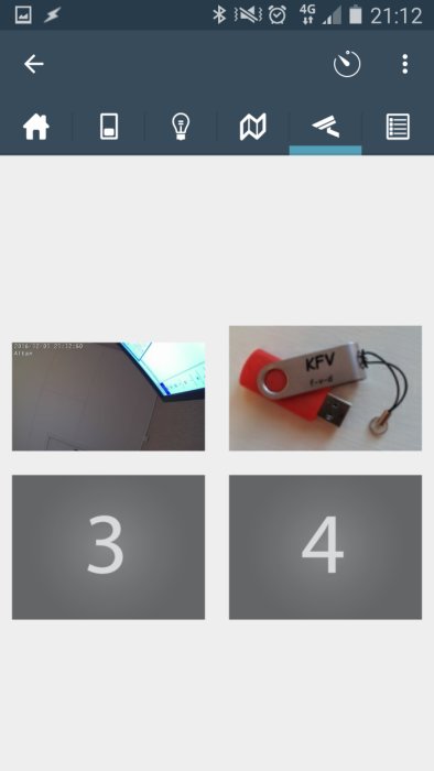 Appgränssnitt med fyra bilder, en visar ett rött USB-minne märkt "KFV".