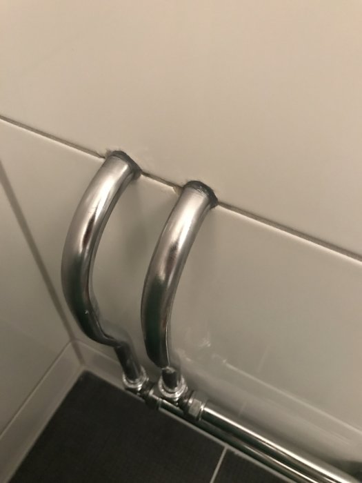 Vattenrör utan synbar tätning mot kakelvägg i renoverat badrum.