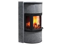 Modern vedeldad kamin med öppen spis i ett hörn med synliga lågor.