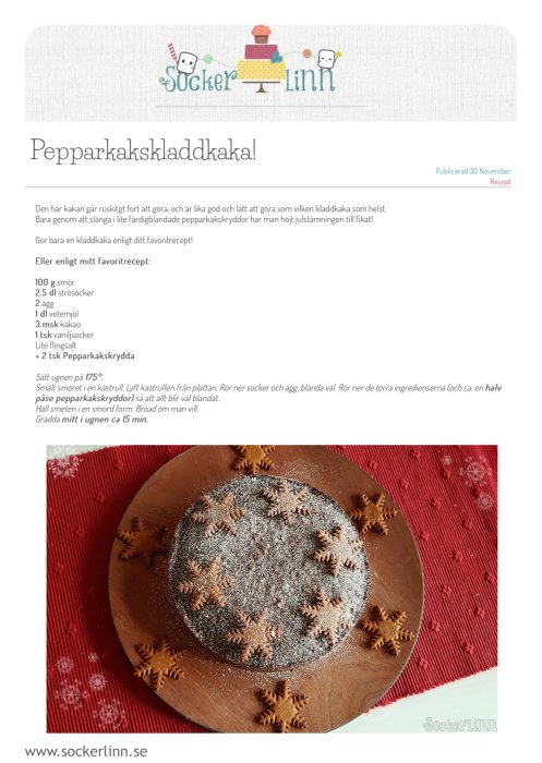 Rund pepparkakskladdkaka dekorerad med pepparkaksfigurer och florsocker, serverad på träfat med röd duk i bakgrunden.