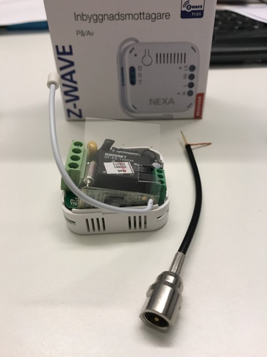 Electronics project with a Z-Wave in-wall receiver and a coaxial cable without a capacitor soldered to the antenna output.