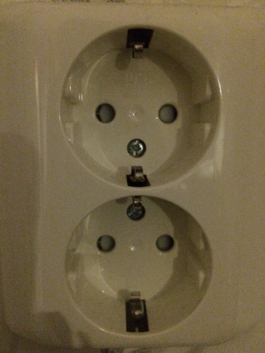 Närbild på ett oanvänt dubbelvägguttag i ett kök.