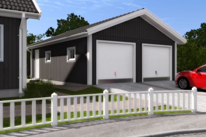 Nybyggd dubbelgarage i anslutning till hus, perfekt för snickarverkstad, med röd bil utanför.