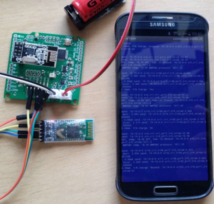 Circuit boards connected to a Samsung phone displaying serial data on screen for debugging.