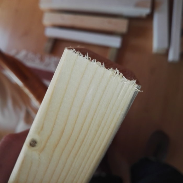 Träplanka med fransiga kanter efter ett misslyckat sågsnitt.