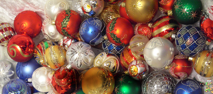 Colorful assortment of decorative Christmas baubles with various patterns and textures.