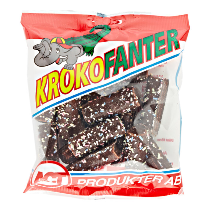 Förpackning av "Krokofanter" godis med synliga chokladdoppade bitar och tecknade elefant och krokodil på etikett.