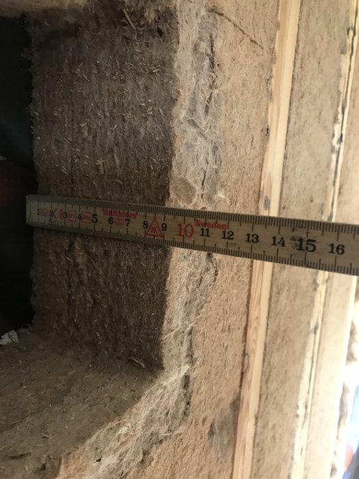 Måttband visar dimensioner på ett igensatt hål i en vägg under en köksrenovering.