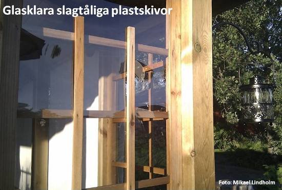 Spaljé i trä med genomskinliga polykarbonatskivor som vindskydd.