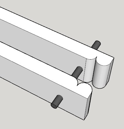 3D-skiss av två parallella skenor med klädnypsliknande ändar och cylindriska låspinnar.