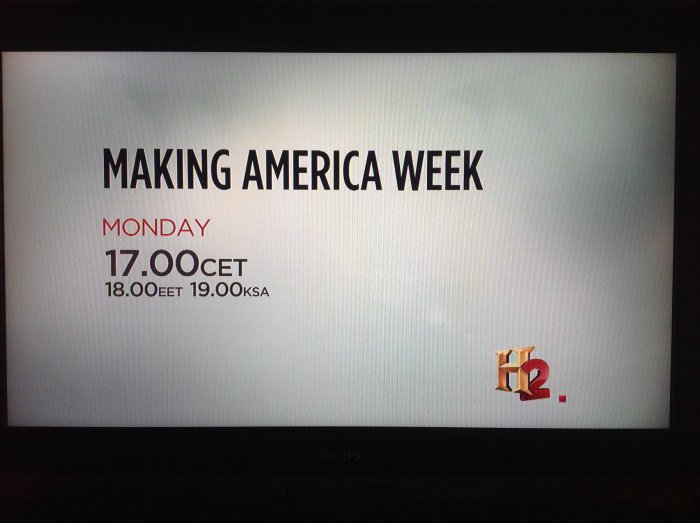 TV-skärm visar texten "MAKING AMERICA WEEK" med sändningstider nedanför.