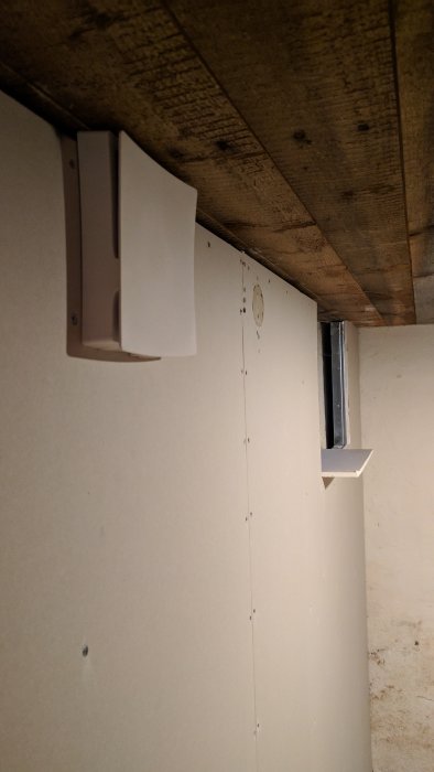 Ventilationskanal i källare med täckplatta installerad över gammalt hål.