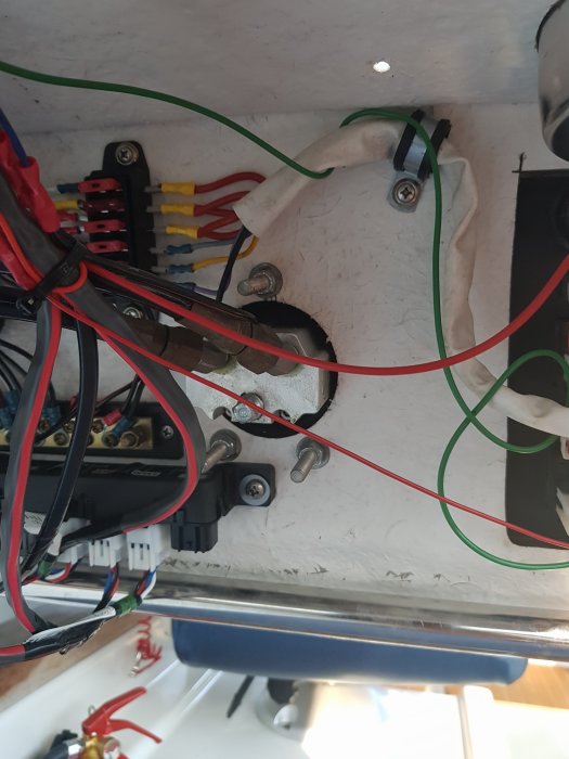 Elektriska kablage och komponenter monterade på en vit yta, möjligtvis en del av byggprojekt.