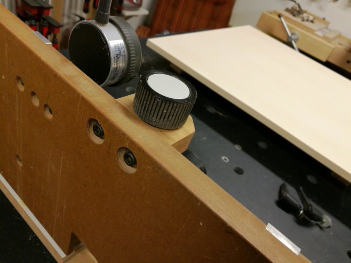 Lagerhuset är fäst underifrån på en arbetsbänk med runda hål och skruvade försänkta brickor för rörelsefrihet.