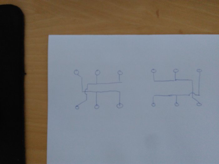 Handritad skiss av en elektrisk koppling med vippan i två olika lägen som visar diagonala hörnanslutningar.