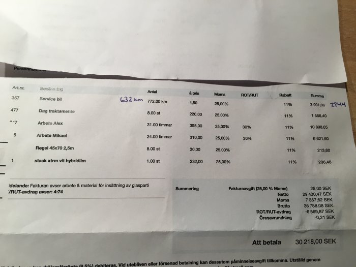 Faktura med poster för byggtjänster och material, inklusive arbetskostnad, material och ROT-avdrag, med god synlighet på totalsumman.