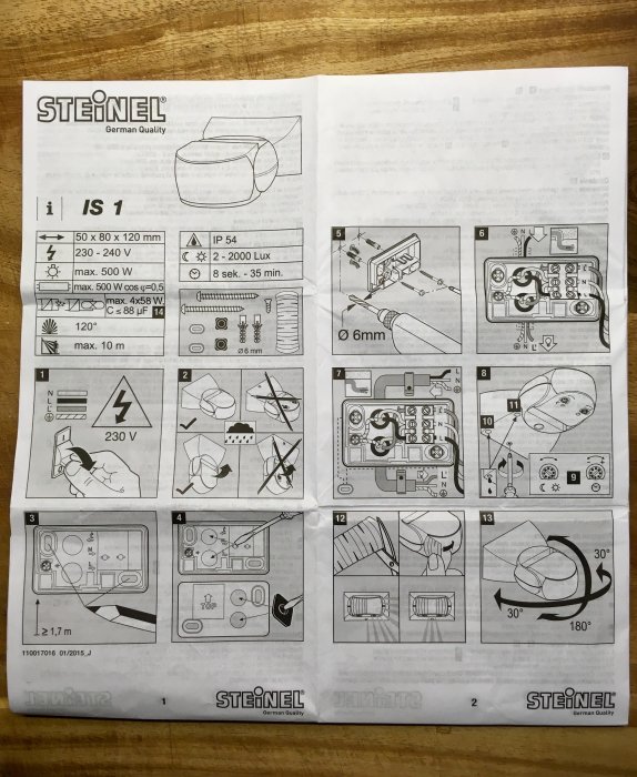 Öppnad instruktionsmanual med illustrationer för installation av Steinel rörelsedetektor, tekniska specifikationer och steg-för-steg bilder.