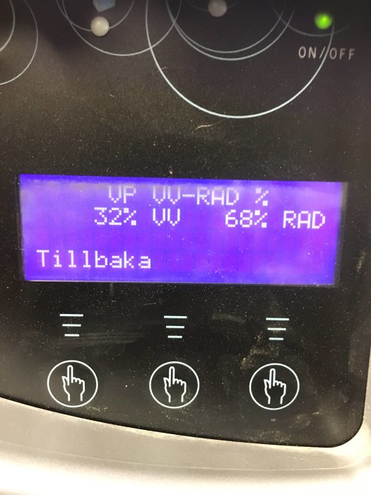 Display på en apparat som visar procentandelar för UV- och RAD-nivåer med knappsymboler för användarinteraktion nedanför.