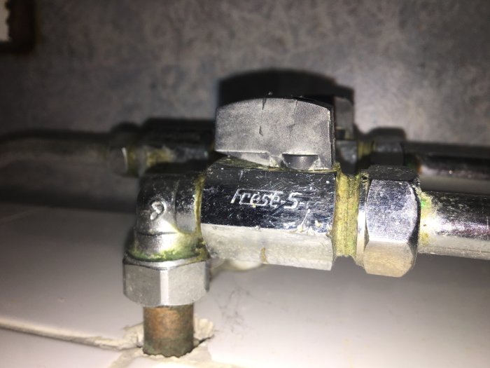 Gammal kulventil märkt med 'Frese - 5' på rörinstallation, med synliga korrosionstecken.