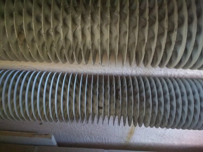 Ovanligt spiralformat element i ett garage täckt av damm som ej blir varmt trots anslutning till bergvärme.