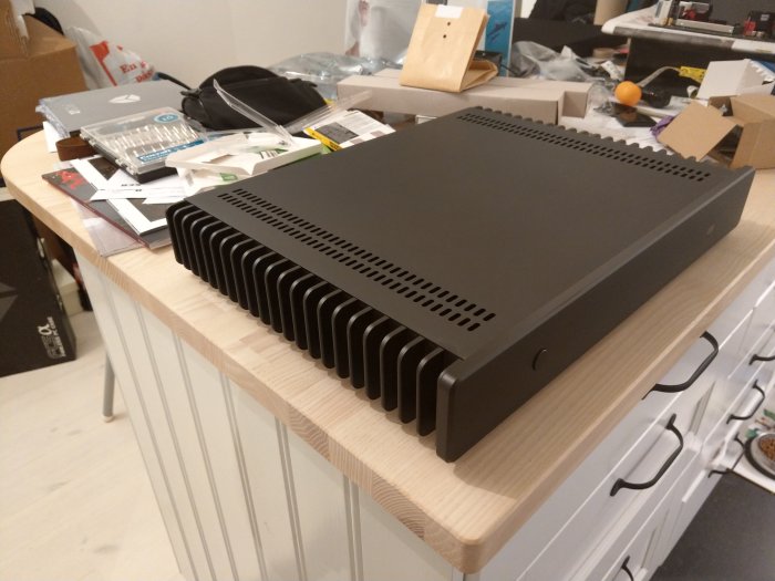 Nytt HTPC-chassi med heatpipes på en bordsskiva, oordning med elektronikkomponenter i bakgrunden.