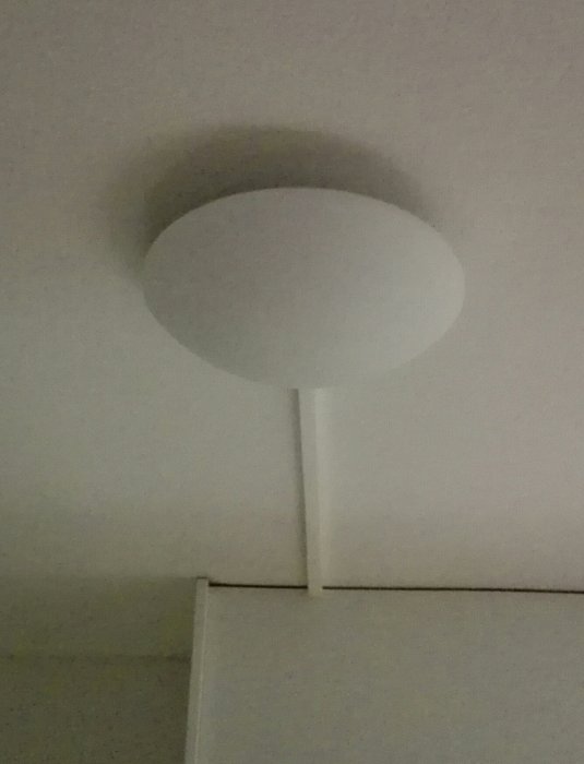 Takmonterad lampa ovanför en väggkant, belysningen behöver uppgraderas och separatas.