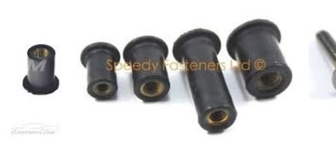 Rad av svarta Rawlnuts gummiexpandrar med mässingsinsats, och en separat skildrad till höger, liggande på en vit yta.