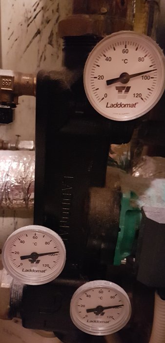 Värmesystem med tre termometrar märkta Laddomat som visar olika temperaturer.