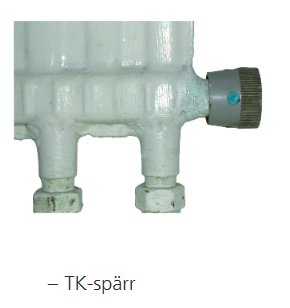 Vit radiator med termostat och TK-spärr märkt.
