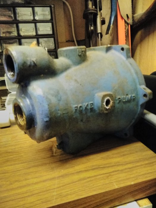 Gammal Foke 2147 vattenpump med två ingångar på en träbänk.
