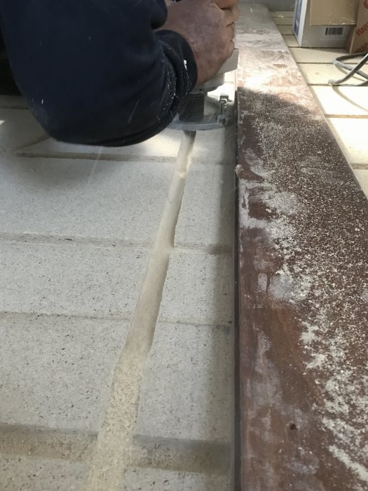 Användning av frässtål för att skapa spår i betonggolv för installation av rör.