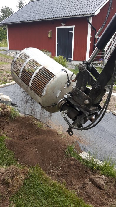 Minigrävare med hemmagjord sorteringsanordning av metall som roterar och sorterar material.