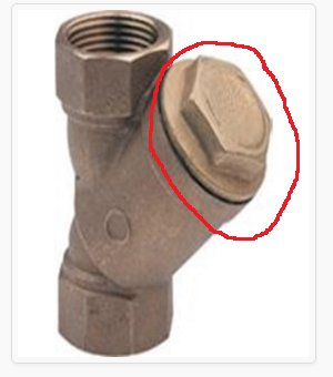 Metallisk vinkelventil med en markerad övre del där ett filter kan bytas ut med speciell tång, utan att stänga ventiler.