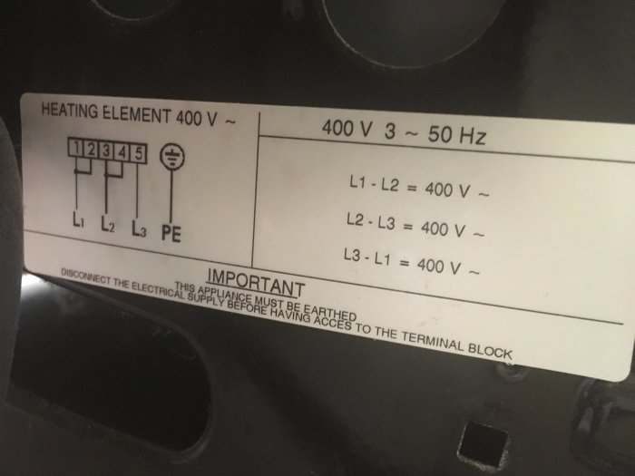 Teknisk etikett på en ugn med specifikationer för elanslutning och varningar.