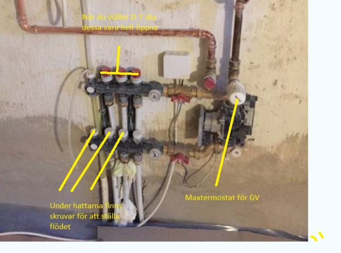 Värmesystem med rör, termostater och reglage för justering av delta-T, potentiell läckage synlig.