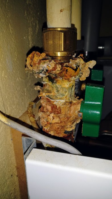 Rostliknande ansamling på koppling vid fjärrvärmeaggregat, nära en temperaturgivarkabel.