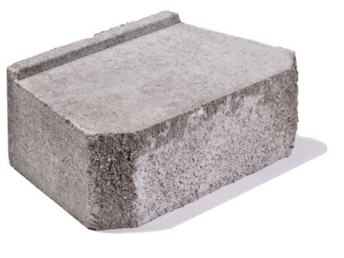 Enstaka grå betongsten använd för murbyggnad eller kantstöd, avbildad mot vit bakgrund.