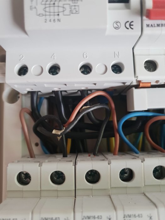 Elskåp med öppna ledningar och säkringar, indikation på potentiellt elektriskt arbete eller felsökning.